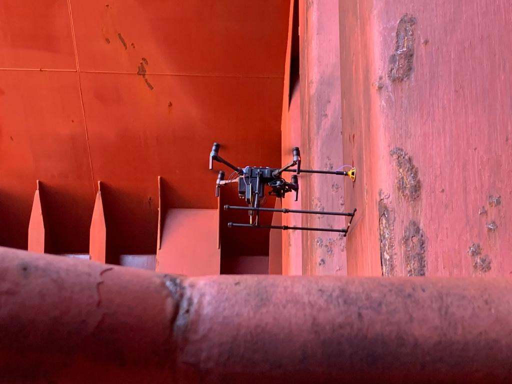 Airborne drone conducting ultrasonic thickness measurements in bulk carrier