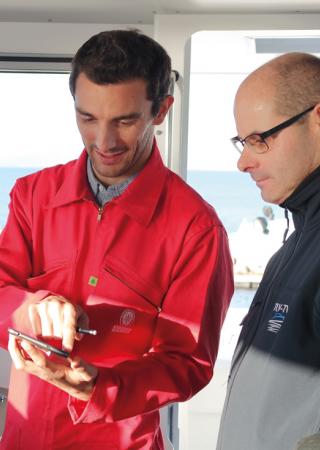 Bureau Veritas Surveyor onboard a ship with a phone